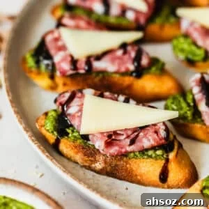 Pesto crostini with parmesan and soppressata.