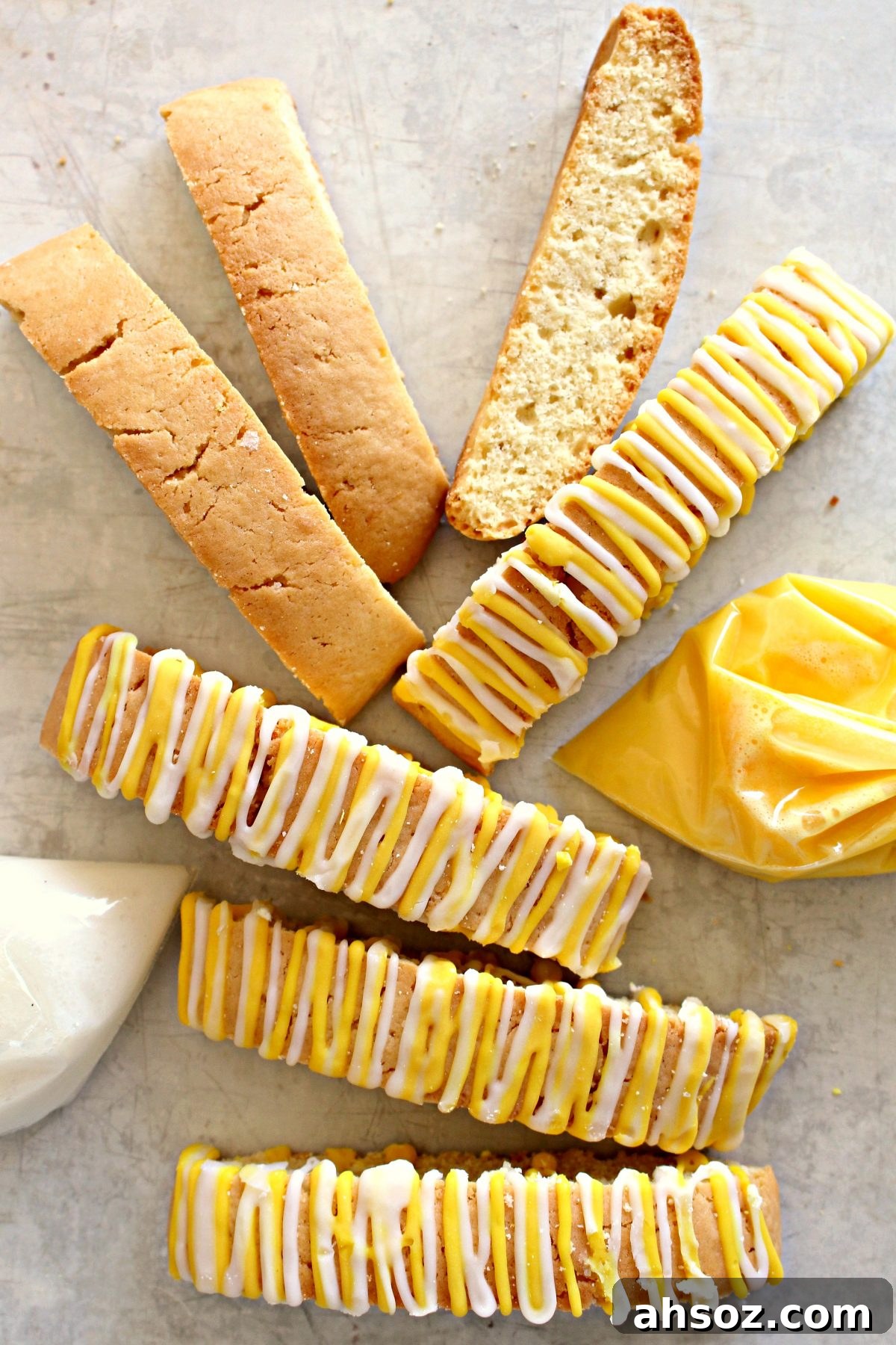 Lemon Biscotti, some decorated with yellow and white icing zigzags on top.