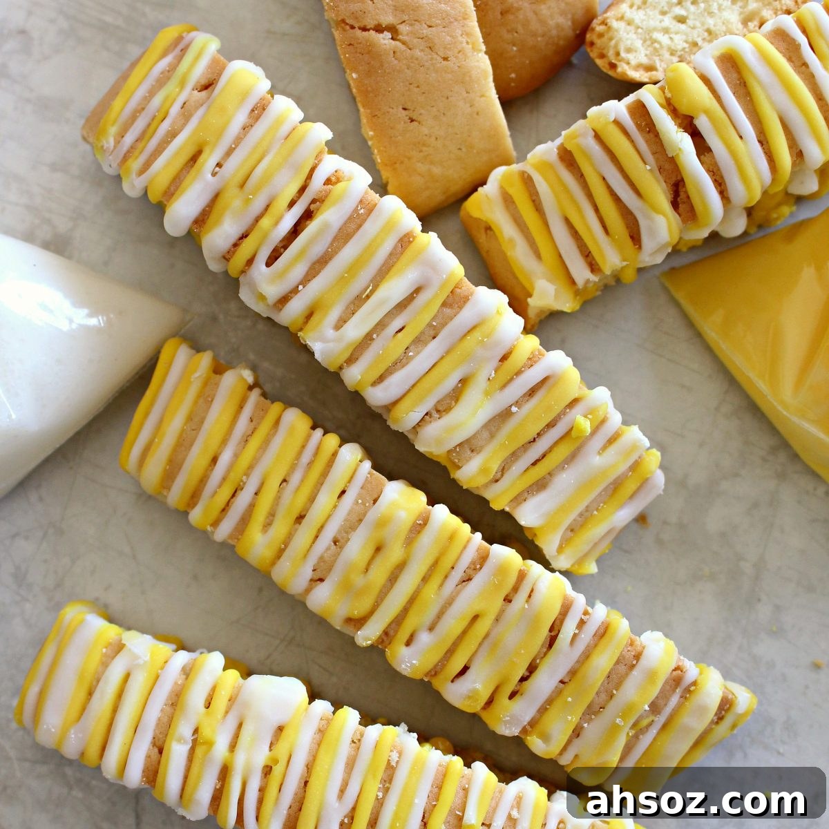 Closeup of yellow and white striped icing on biscotti tops.