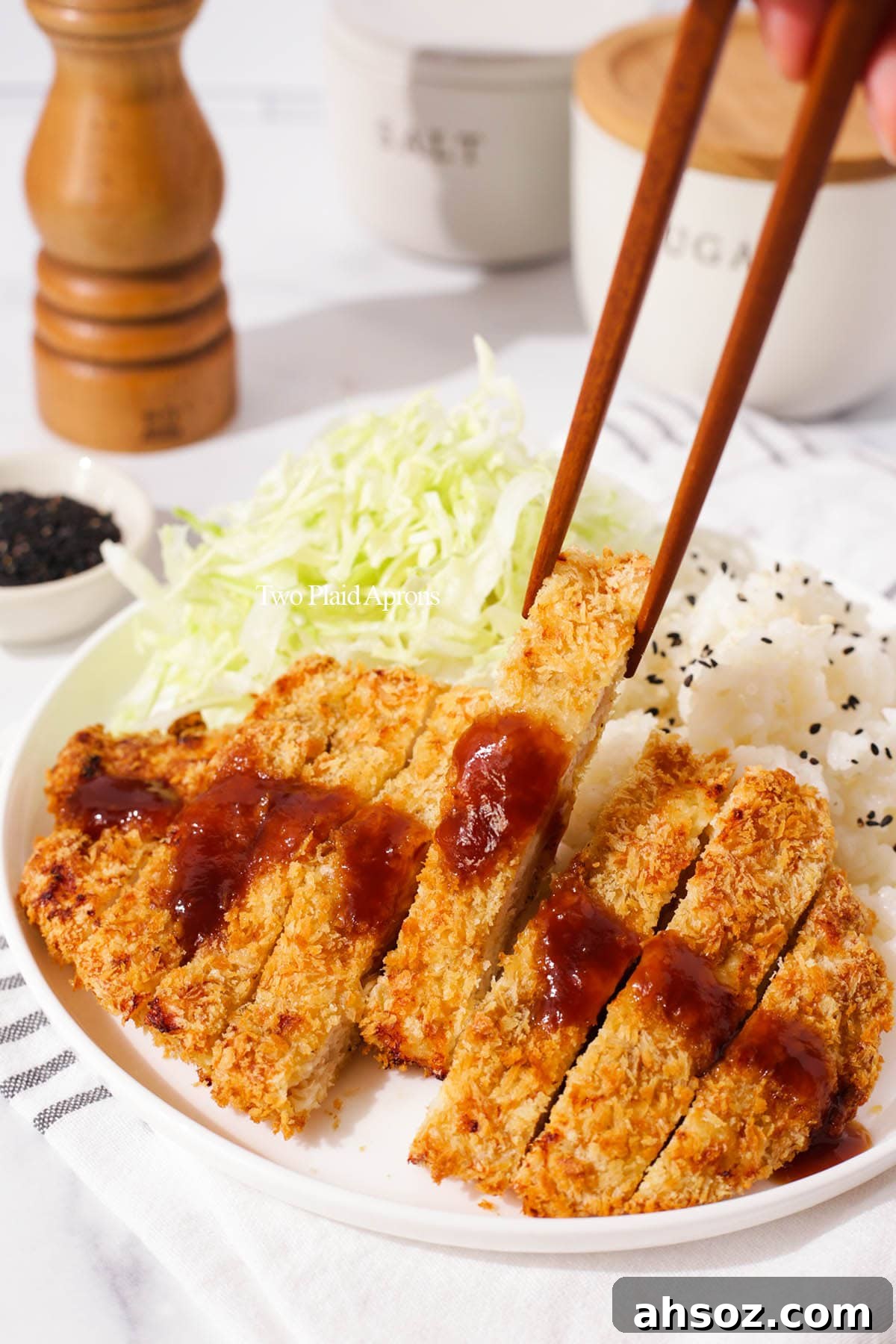 Air fryer chicken katsu served with rice, cabbage, and katsu sauce.