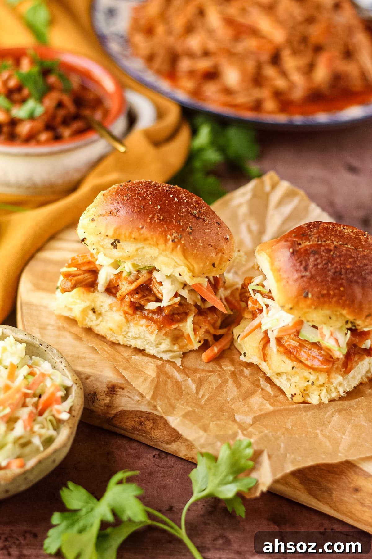 Barbecue pulled chicken sliders with southern coleslaw on a wooden cutting board