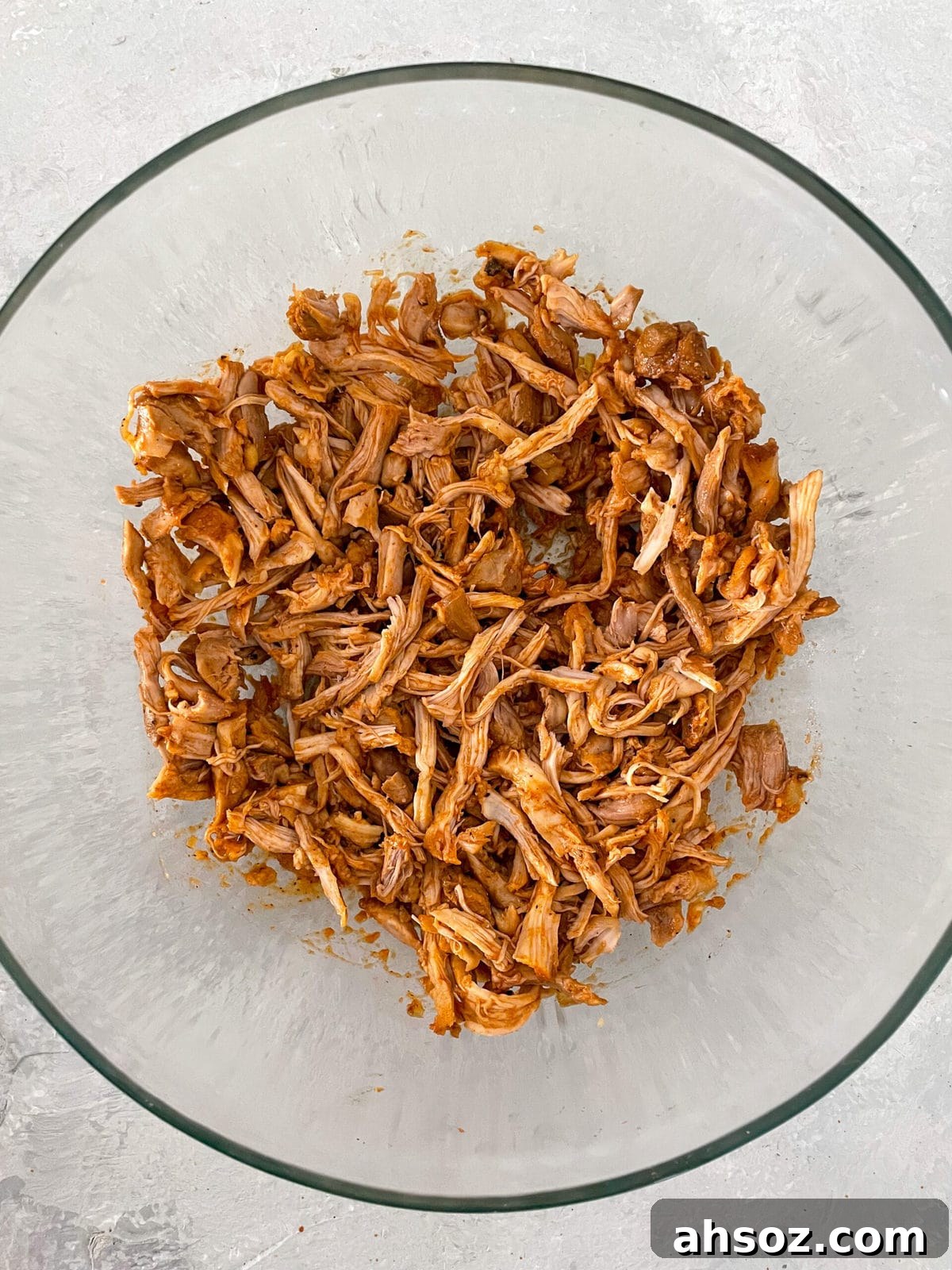 Barbecue pulled chicken in a clear glass bowl