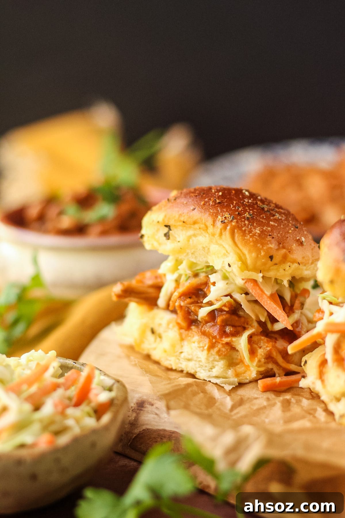 Barbecue pulled chicken sliders with southern coleslaw on a wooden cutting board