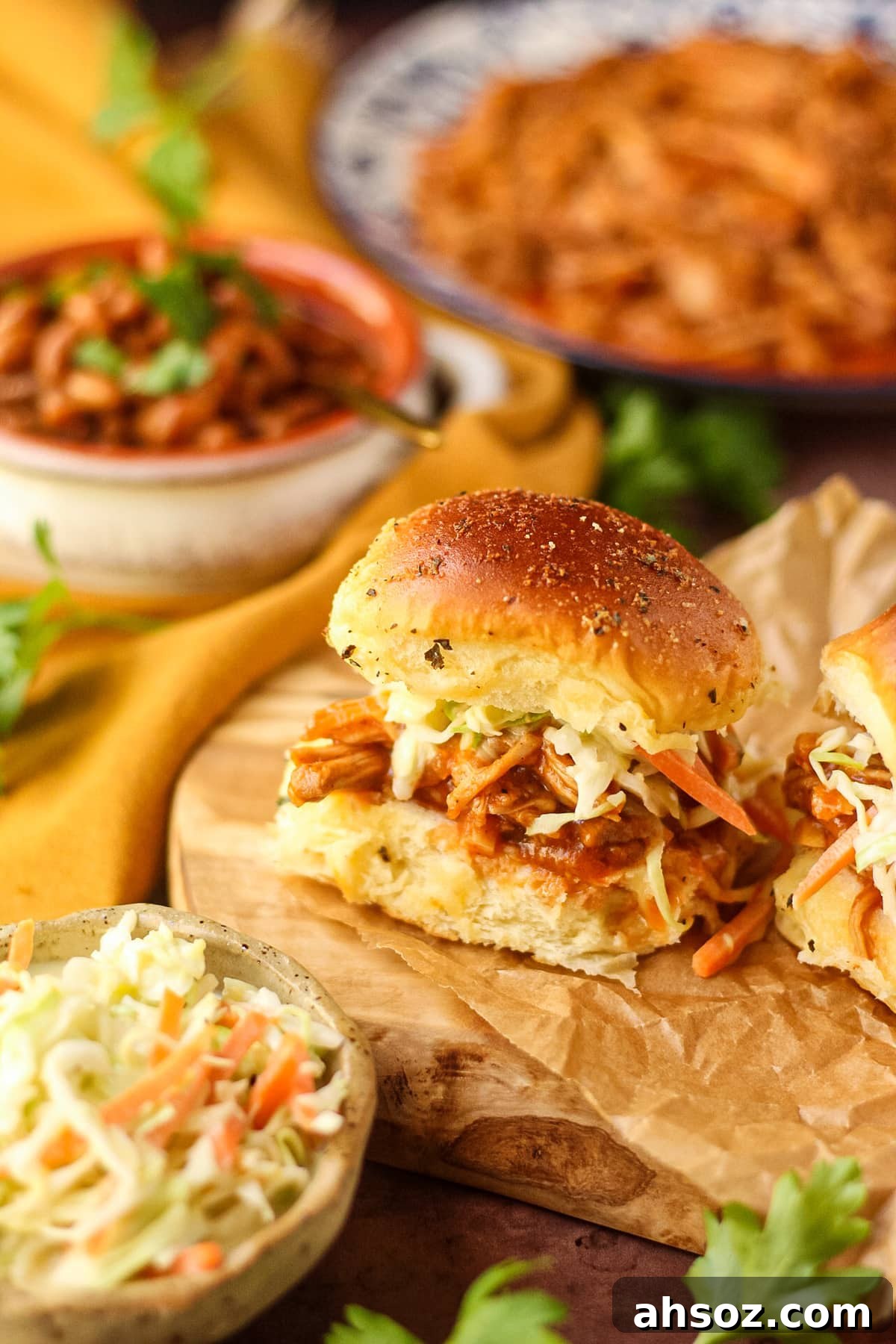 Barbecue pulled chicken sliders with southern coleslaw on a wooden cutting board