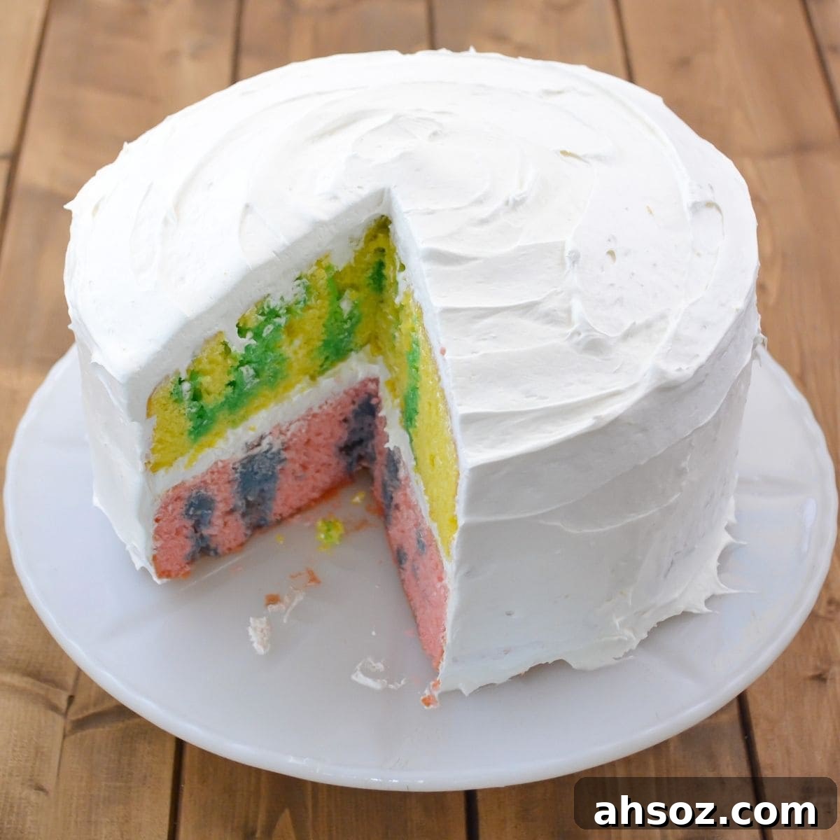Easter Jello Poke Cake with a slice cut on a cake stand.