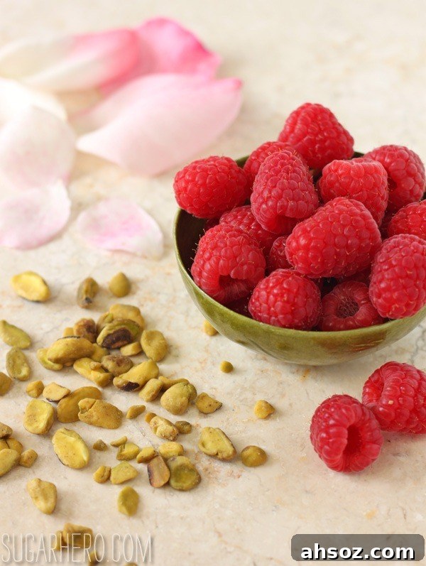 Mini pistachio rose tarts with raspberry garnish