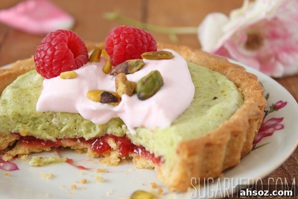 Pistachio rose tarts topped with raspberries and whipped cream