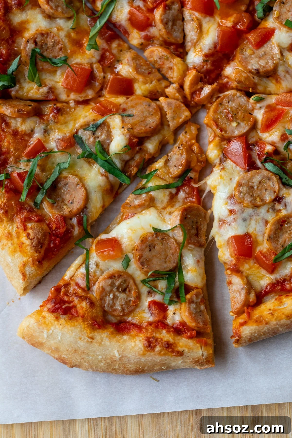 slice of chicken sausage pizza removed from the rest of the pizza