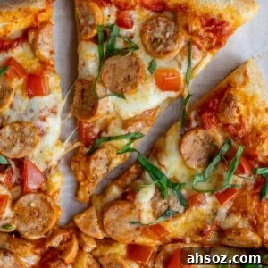 slice of chicken sausage pizza removed from the rest of the pizza